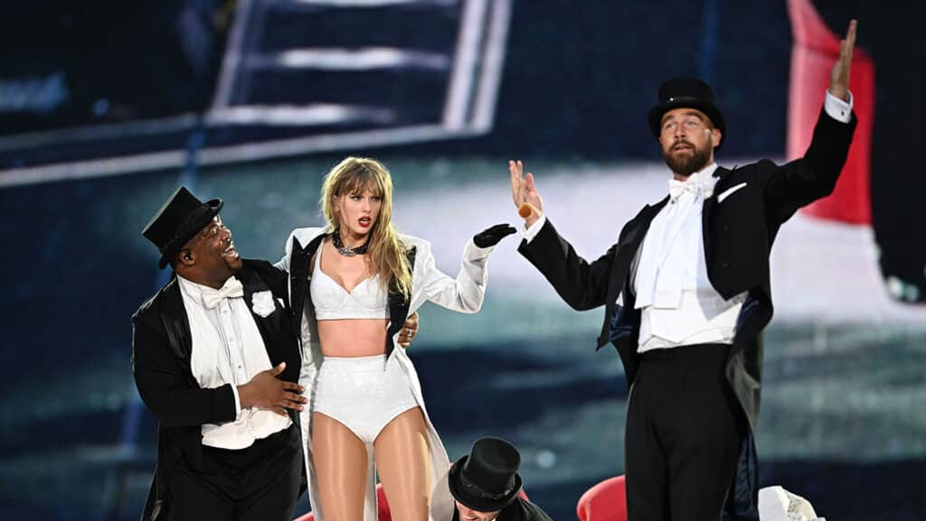 Taylor Swift is joined on stage by Travis Kelce (R), during "Taylor Swift