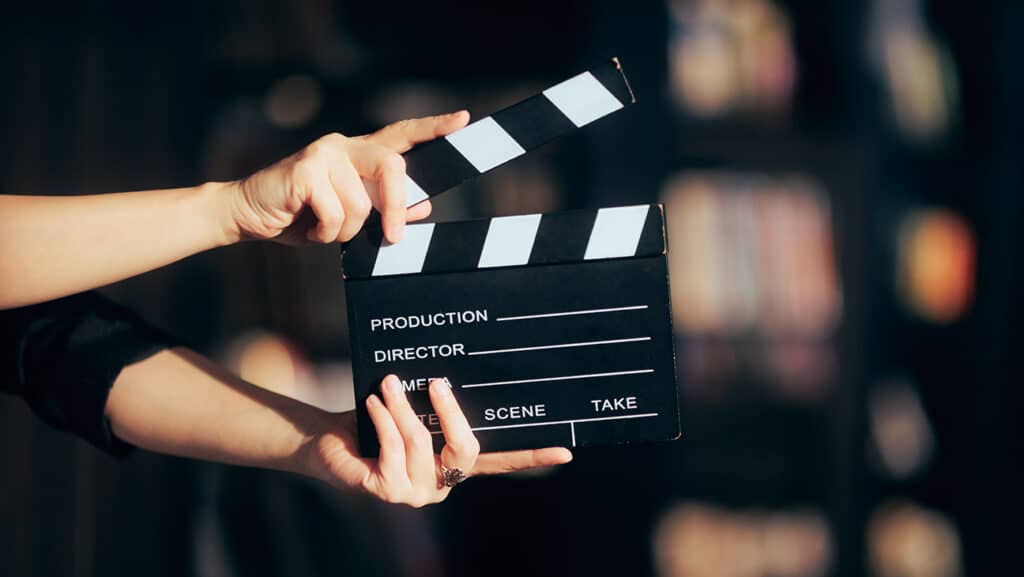 Cinematography filmmaking conceptual image in between takes, Hands Holding a Film Slate Directing a Movie Scene