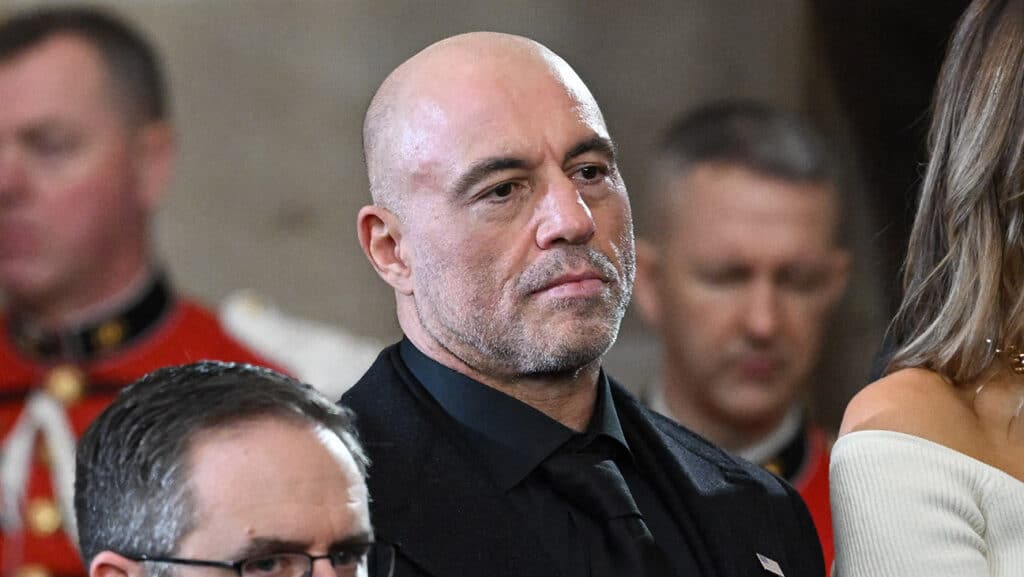 Joe Rogan stands for a benediction after President Donald Trump was sworn in as the 47th US President in the US Capitol Rotunda in Washington, DC, on January 20, 2025.