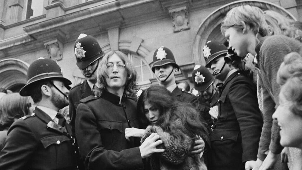 British singer, songwriter and musician John Lennon (1940 - 1980) and his girlfriend Yoko Ono leave Marylebone Magistrates' Court in London, after their hearing on charges of drug possession, 19th October 1968.