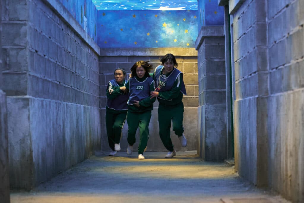 Squid Game Season 3 action scene with Cho Yu-ri as Jun-Hee running with teammates