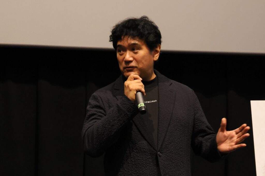 （写真）エグゼクティブプロデューサー志賀司／愛知県日進市での特別先行上映会にて