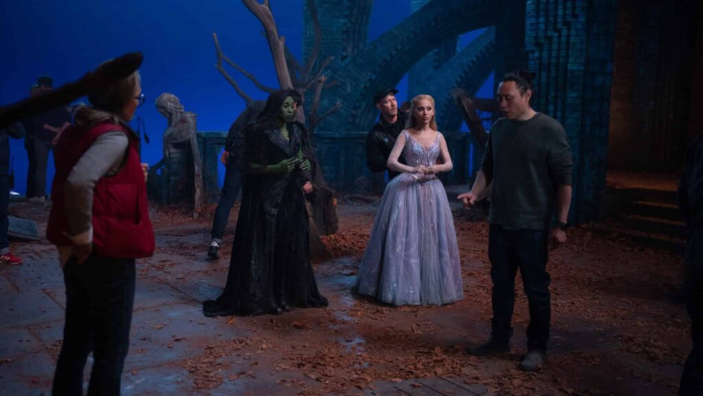 (左から)シンシア・エリヴォ、アリアナ・グランデ、ジョン・M・チュウ監督、『ウィキッド 永遠の約束』撮影現場にて